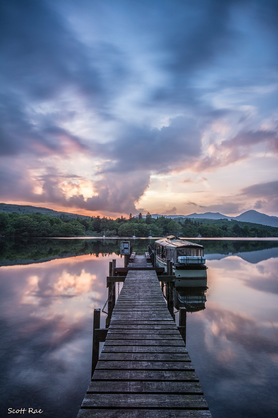 Boat-at-sunset 
 Keywords: lake uk transport nw england water sunset summer mountains